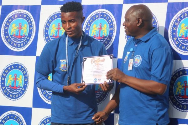 Congolese striker Yema Mwama being honoured by Bernard Osero, Bandari FC Vice Chairman and Head of Corporate Affairs after being emerging as the club top scorer and top striker in SportPesa Shield and SportPesa Premier League Kipevu Container Terminal in Mombasa on June 17, 2019. PHOTO/SPN