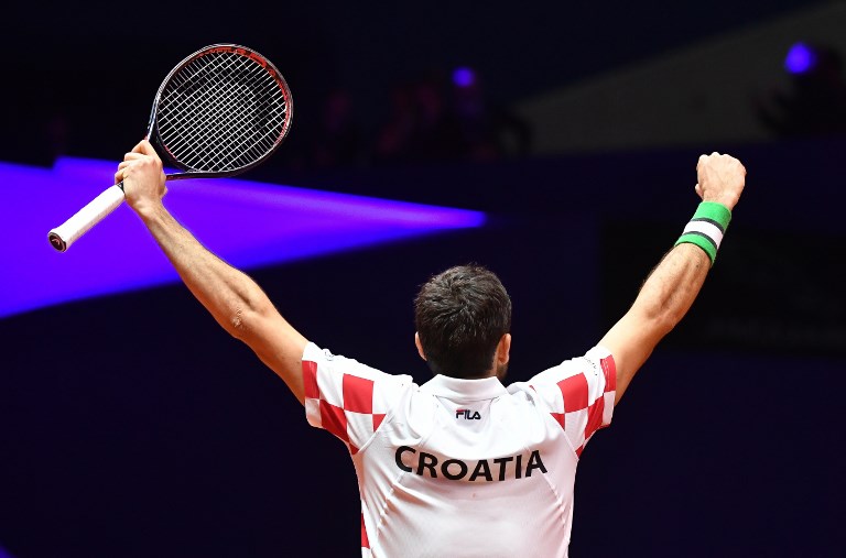 Croatia's Marin Cilic celebrates after victory in his singles rubber against France's Jo-Wilfried Tsonga during the Davis Cup final tennis match between France and Croatia at The Pierry-Mauroy Stadium at Villeneuve d'Ascq in northern France on November 23, 2018.PHOTO/ AFP
