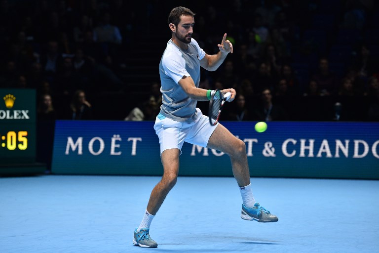 Croatia's Marin Cilic returns against Serbia's Novak Djokovic in their men's singles round-robin match on day six of the ATP World Tour Finals tennis tournament at the O2 Arena in London on November 16, 2018. PHOTO/AFP