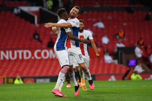 Crystal Palace's Ivorian striker Wilfried Zaha (L) celebrates with Crystal Palace's Scottish midfielder James McArthur (R) after scoring their second goal during the English Premier League football match between Manchester United and Crystal Palace at Old Trafford in Manchester, north west England, on September 19, 2020. PHOTO | AFP