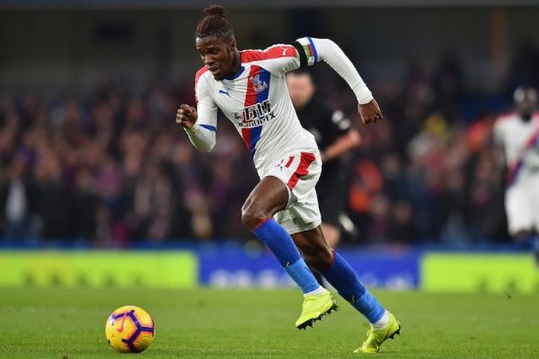 Crystal Palace's Ivorian striker Wilfried Zaha runs with the ball during the English Premier League football match between Chelsea and Crystal Palace at Stamford Bridge in London on November 4, 2018. 