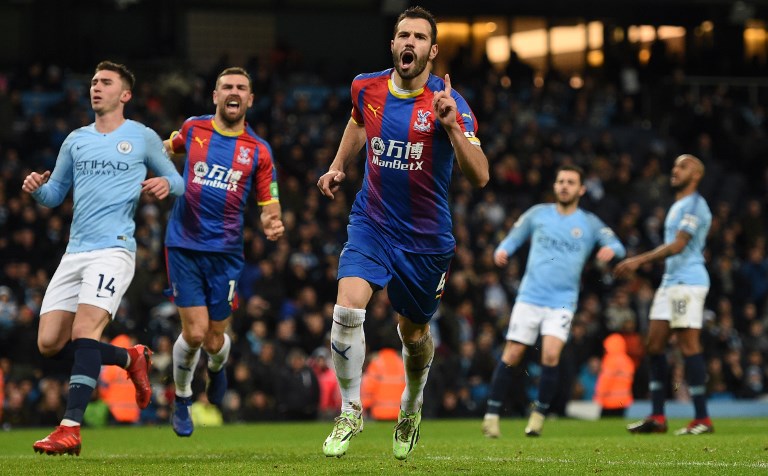 Crystal Palace's Serbian midfielder Luka Milivojevic (C) celebrates scoring their third goal from the penalty spot to extend their lead 1-3 during the English Premier League football match between Manchester City and Crystal Palace at the Etihad Stadium in Manchester, north west England, on December 22, 2018. PHOTO/AFP