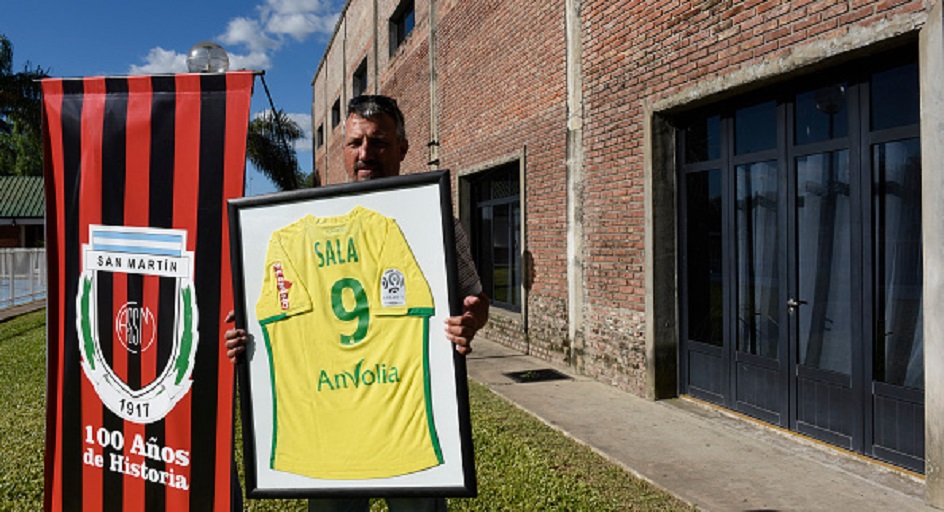 Daniel Ribero President of San Martin Club poses with Sala's framed jersey at the club where Emiliano Sala's wake will take place on February 15, 2019 in Progreso, Argentina. 28-year-old striker was killed when the private plane carrying him from Nantes to Cardiff crashed in the English Channel near Alderney on January 21. Sala's body was recovered from the wreckage on February 6 and pilot David Ibbotson remains missing. PHOTO/GettyImages