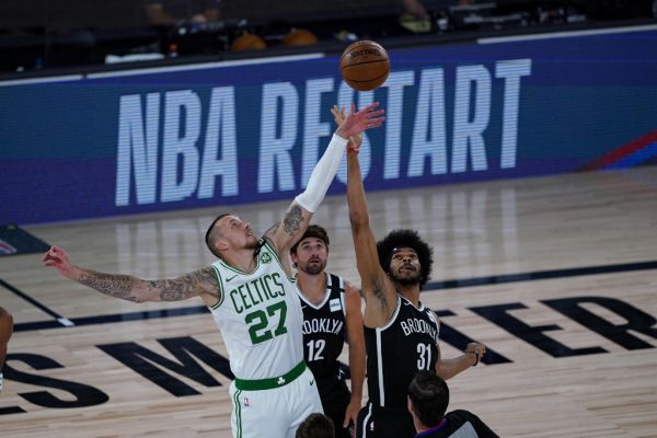 Daniel Theis #27 of the Boston Celtics and Jarrett Allen #31 of the Brooklyn Nets battle for the opening tip-off at The Arena at ESPN Wide World Of Sports Complex on August 5, 2020 in Lake Buena Vista, Florida. PHOTO | AFP