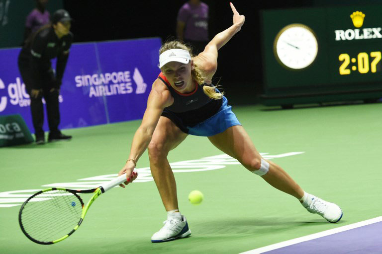 Denmark's Caroline Wozniacki hits a return against Ukraine's Elina Svitolina during their singles match at the WTA Finals tennis tournament in Singapore on October 25, 2018. PHOTO/AFP
