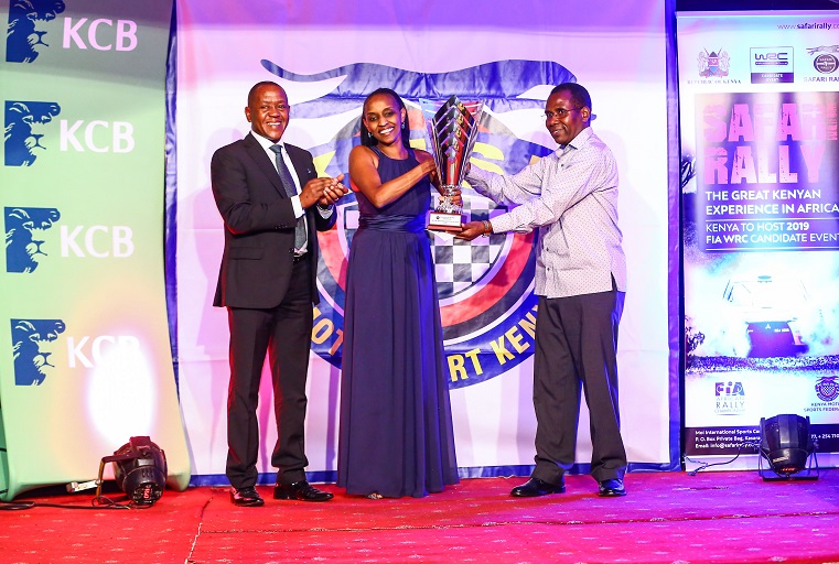 Deputy Secretary Ministry of Sports, Culture & Heritage, Wesley K. Maritim (right) with the Kenya Motorsports Federation- Chairman, Phineas Kimathi, as they present a trophy to the Motorsports Personality of the year, Tuta Mionki.PHOTO/SPN