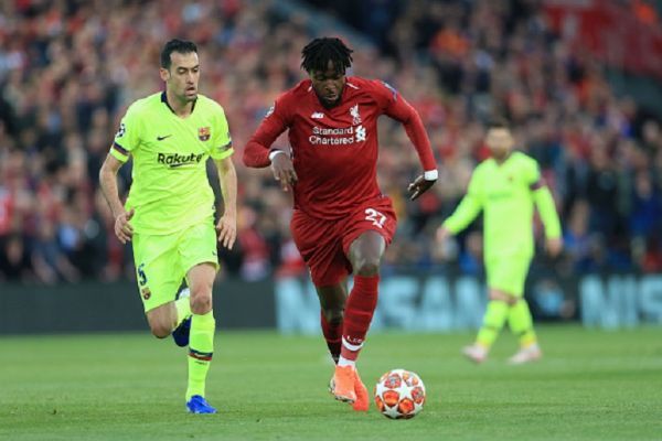 Divock Origi of Liverpool battles with Sergio Busquets of Barcelona during the UEFA Champions League Semi Final second leg match between Liverpool and FC Barcelona at Anfield on May 7, 2019 in Liverpool, England. PHOTO/ GETTY IMAGES