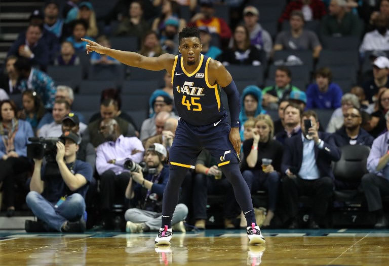 Donovan Mitchell #45 of the Utah Jazz watches on against the Charlotte Hornets during their game at Spectrum Center on November 30, 2018 in Charlotte, North Carolina.PHOTO/AFP