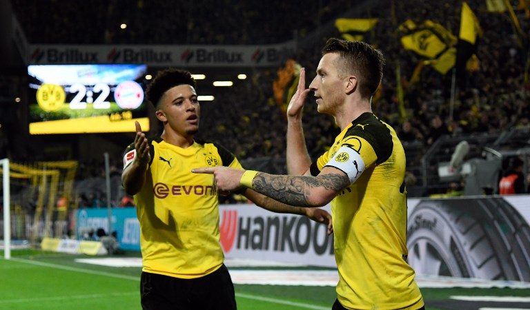 Dortmund's German forward Marco Reus celebrate (R) after scoring with Dortmund's English midfielder Jadon Sancho during the German first division Bundesliga football match BVB Borussia Dortmund v FC Bayern Munich in Dortmund, western Germany, on November 10, 2018. PHOTO/ AFP