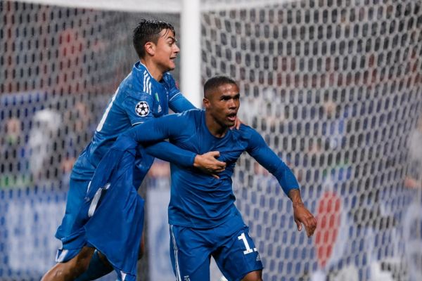 Douglas Costa (R) of Juventus celebrates his goal with Paulo Dybala during the UEFA Champions League Group D match between Lokomotiv Moskva and Juventus FC on November 6, 2019 at RZD Arena in Moscow, Russia. PHOTO | AFP