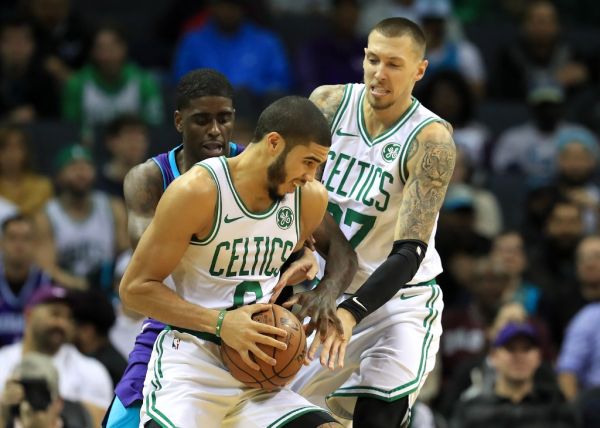 Dwayne Bacon #7 of the Charlotte Hornets tries to get the ball from teammates Jayson Tatum #0 and Daniel Theis #27 of the Boston Celtics during their game at Spectrum Center on November 07, 2019 in Charlotte, North Carolina. PHOTO | AFP