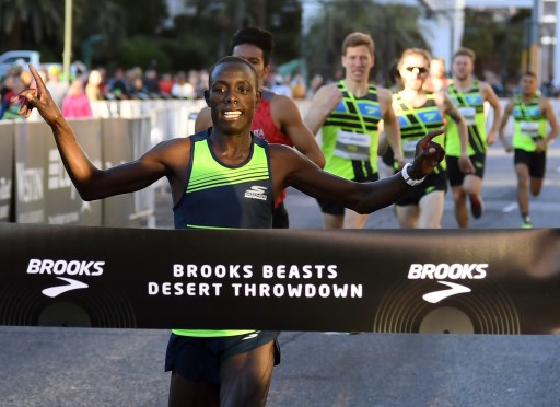 Edward Cheserek crosses the finish line as the men's first-place finisher in the Brooks Beasts Desert Throwdown, a one-mile invitational race hosted by the Toyota Rock 'n' Roll Las Vegas Marathon and Half Marathon, on the Las Vegas Strip on November 11, 2018. PHOTO/AFP