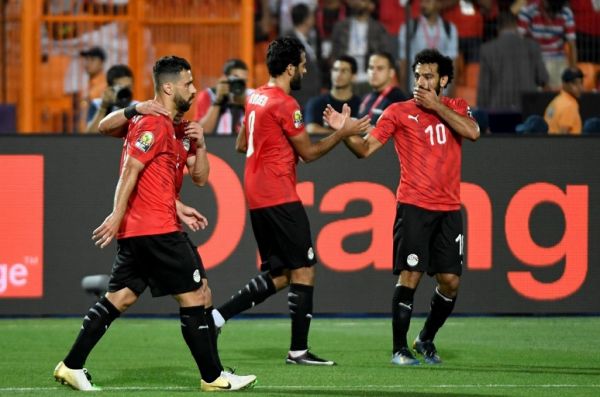 Egypt's forward Marwan Mohsen (C) and Egypt's forward Mohamed Salah (R) celebrate after scoring a goal during the 2019 Africa Cup of Nations (CAN) football match between Egypt and DR Congo at the Cairo International Stadium on June 26, 2019. PHOTO | AFP