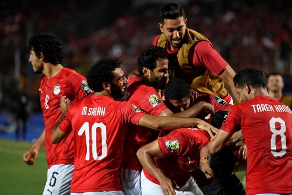 Egypt's forward Mohamed Salah (2nd-L) greets Egypt's midfielder Mahmoud 'Trezeguet' Hassan as he celebrates after scoring a goal during the 2019 Africa Cup of Nations (CAN) football match between Egypt and Zimbabwe at Cairo International Stadium on June 21, 2019. PHOTO | AFP