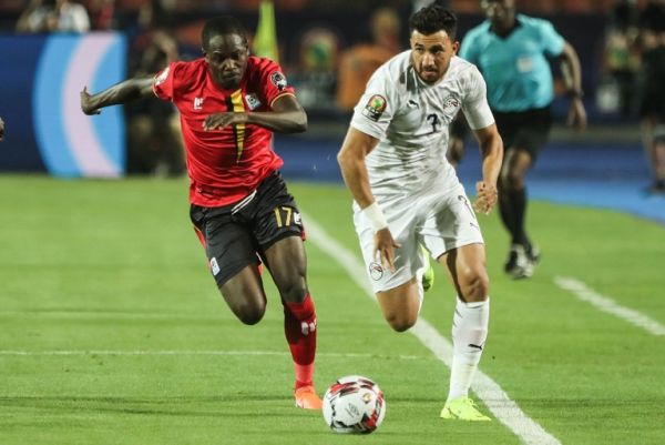 Egypt's Mahmoud Hassan Trezeguet (R) and Uganda's Farouk Miya vie for the ball during the 2019 Africa Cup of Nations Group A soccer match between Egypt and Uganda at Cairo International Stadium. PHOTO | AFP