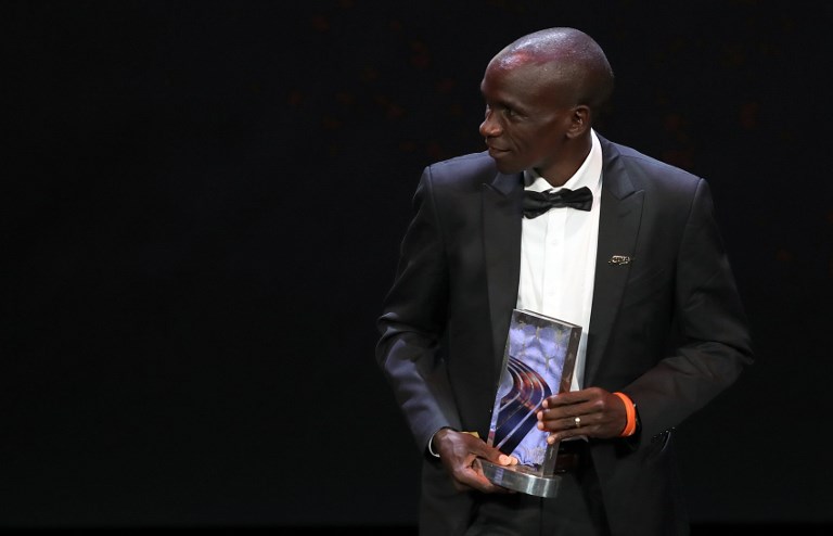 Eliud Kipchoge poses with his 2018 IAAF Athlete of the Year Award at the World Gala in Monaco on December 4, 2018. PHOTO/AFP 