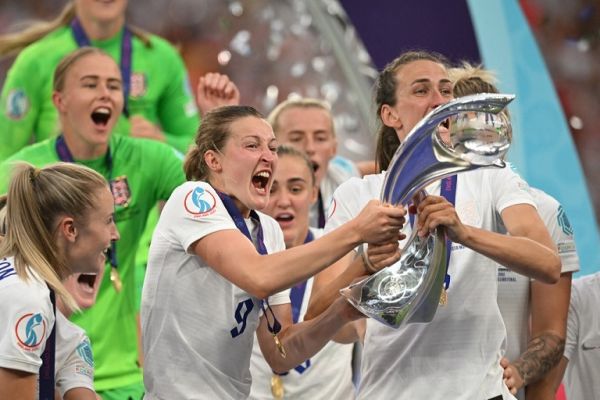 England's striker Ellen White (L) and England's midfielder Jill Scott (R) lift the trophy as England's players celebrate after their win in the UEFA Women's Euro 2022 final football match between England and Germany at the Wembley stadium, in London, on July 31, 2022. England won a major women's tournament for the first time as Chloe Kelly's extra-time goal secured a 2-1 victory over Germany at a sold out Wembley on Sunday. PHOTO | AFP