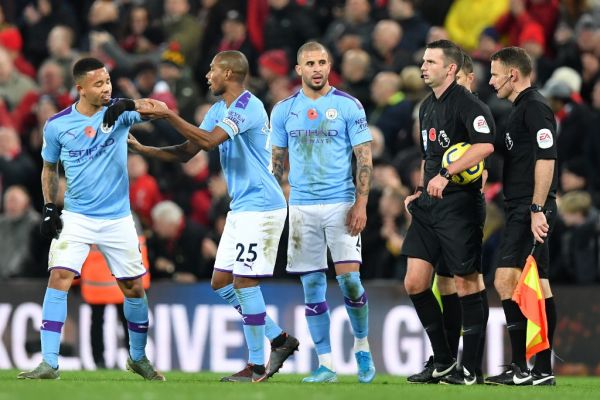 English referee Michael Oliver and his officials stand with Manchester City's Brazilian striker Gabriel Jesus (L), Manchester City's Brazilian midfielder Fernandinho (2nd L) and Manchester City's English defender Kyle Walker (3rd L) on the pitch after the English Premier League football match between Liverpool and Manchester City at Anfield in Liverpool, north west England on November 10, 2019. Liverpool won the game 3-1. PHOTO | AFP