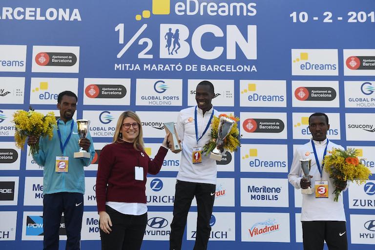 Eric Kiptanui (centre) receives his trophy after winning the Barcelona Half Marathon on Sunday, February 10, 2018. PHOTO/Courtesy/Organisers