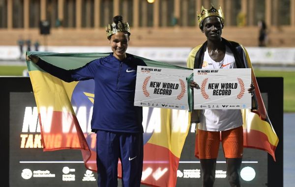 Ethiopian athlete Letesenbet Gidey (L) and Ugandan athlete Joshua Cheptegei pose after breaking the 5,000m and 10,000m track world records, respectively, during the NN Valencia World Record Day at the Turia stadium in Valencia on October 7, 2020. Joshua Cheptegei broke the 10,000m track world record with a time of 26mins 11seconds while Letesenbet Gidey set a new women's 5,000m world record of 14 minutes 6.65 seconds today in Valencia. PHOTO | AFP