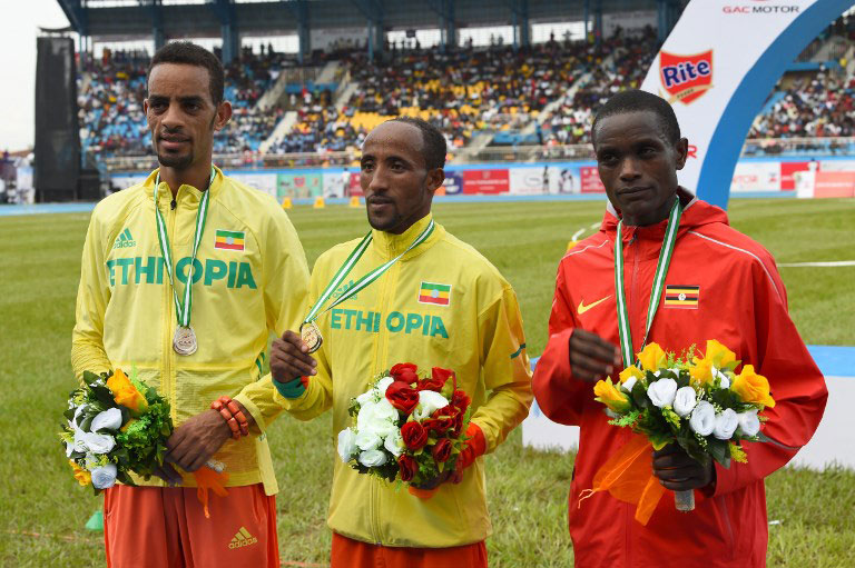 Ethiopian athletes Berta Andamlak (L silver medal), Jemal Mekonnen (C gold medal) and Ugandian athlete Timothy Toroitich (R bronze) celebrate their medals in the tournament in the 10,000 race during the opening of the 21st African Senior Athletics Championships at the Stephen Keshi Stadium in Asaba, Delta State in Midwestern Nigeria, on August 1, 2018. PHOTO/AFP
