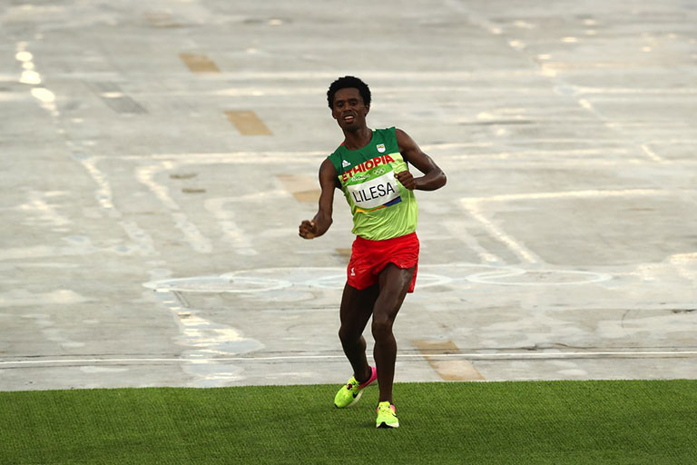 Ethiopian dissident marathoner, Feyisa Lilesa, soon after crossing the line at the Rio 2016 Olympics in Brazil for silver. PHOTO/Getty Images/IOC
