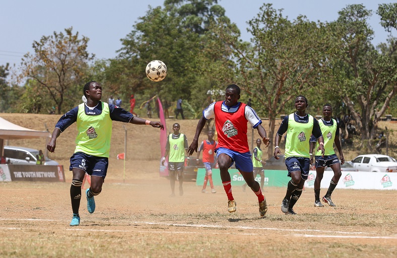 Eugene Oluoch of Mukumu Boys (left) contest for the against Dennis Alusa of  Lungari Blue Saints during  Western-Region Chapa Dimba contest at Kanduyi Stadium.Mukumu Boys won 2-0.PHOTO/COURTESY
