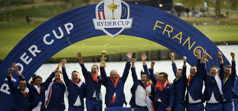 Europe's Italian golfer Francesco Molinari, English golfer Tommy Fleetwood, English golfer Tyrrell Hatton, English golfer Paul Casey, Danish captain Thomas Bjorn, Northern Irish golfer Rory McIlroy, Swedish golfer Alexander Noren, Danish golfer Thorbjorn Olesen, English golfer Ian Poulter, Spanish golfer Jon Rahm, English golfer Justin Rose and Swedish golfer Henrik Stenson celebrate with the trophy after winning the 42nd Ryder Cup at Le Golf National Course at Saint-Quentin-en-Yvelines, south-west of Paris, on September 30, 2018. PHOTO/AFP