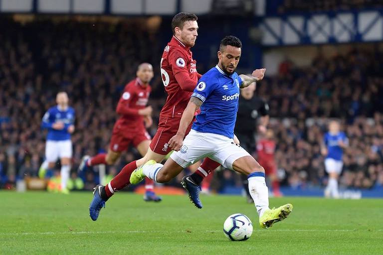 Everton FC winger Theo Walcott shapes to shoot with Liverpool's Jordan Henderson (background) keeping close attendance in their EPL Merseyside Derby on Sunday, March 3, 2019. PHOTO/Everton