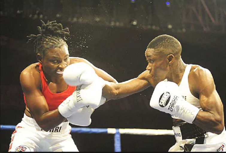 Fatuma 'Iron Fist' Zarika punches Zambian Catherine Phiri during their WBC Super bantamweight title fight at the Carnivore Grounds in Nairobi on December, 2, 2017. PHOTO/Nairobinews