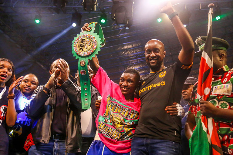 Fatuma Zarika (centre) and SportPesa CEO, Captain Ronald Karauri (2nd R) celebrate after the former defended her WBC Women Super Bantamweight title in  Nairobi on Saturday, September 8, 2018. PHOTO/SPN