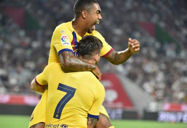 FC Barcelona's forward Carles Perez (#7) celebrates his goal with teammate Malcom (top) during the Rakuten Cup football match between Vissel Kobe and FC Barcelona, in Kobe on July 27, 2019. PHOTO/AFP