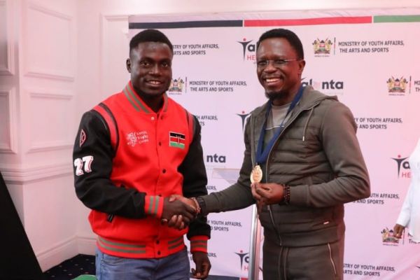 Festus Shiasi and Sports CS Ababu Namwamba. PHOTO| MOYASA