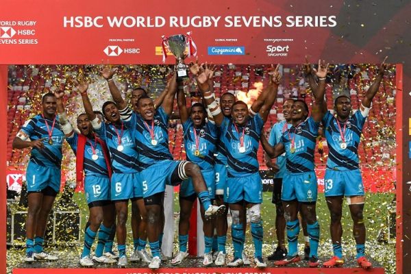 Fiji's players celebrate with the trophy after winning the Singapore Rugby Sevens cup final match between New Zealand and Fiji in Singapore on April 10, 2022. PHOTO | AFP