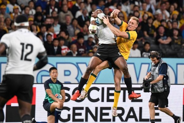 Fiji's wing Semi Radradra (L) and Australia's wing Reece Hodge compete for the ball during the Japan 2019 Rugby World Cup Pool D match between Australia and Fiji at the Sapporo Dome in Sapporo on September 21, 2019. PHOTO | AFP