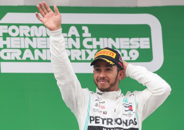 File photo taken on April 14, 2019 shows Mercedes driver Lewis Hamilton of Britain celebrating on the podium after winning the Chinese Formula One Grand Prix at the Shanghai International Circuit in Shanghai, east China. Mercedes driver Lewis Hamilton was crowned Formula 1 world champion for the sixth time this season with 413 points. The 34-year-old Briton is now just one title shy of Michael Schumacher's record of seven. PHOTO | AFP