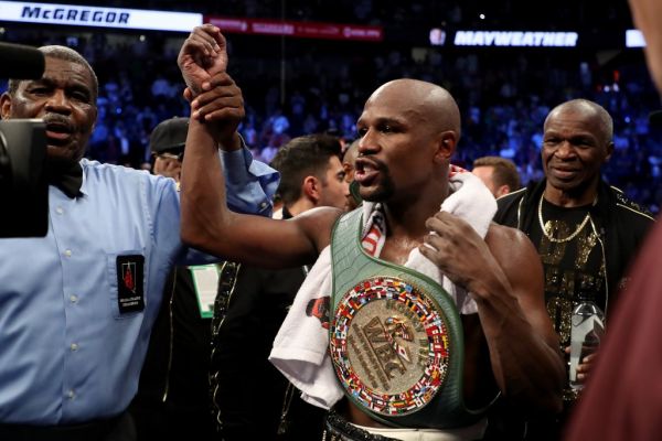 Floyd Mayweather Jr. celebrates with the WBC Money Belt after his TKO of Conor McGregor in their super welterweight boxing match on August 26, 2017 at T-Mobile Arena in Las Vegas, Nevada. PHOTO | AFP