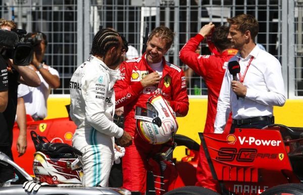 Formula 1 rivals, Louis Hamilton (left) and Sebastian Vettel (centre) chat after the final qualifying for the Canadian Grand Prix on Saturday, June 8, 2019. PHOTO/AFP