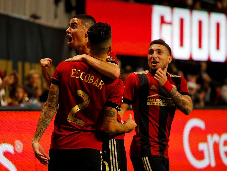 Franco Escobar (left) of Atlanta United celebrates scoring the second goal against the New York Red Bulls with Miguel Almiron and Eric Remedi in the second half of the MLS Eastern Conference Finals between Atlanta United and the New York Red Bulls at Mercedes-Benz Stadium on November 25, 2018 in Atlanta, Georgia. PHOTO/AFP