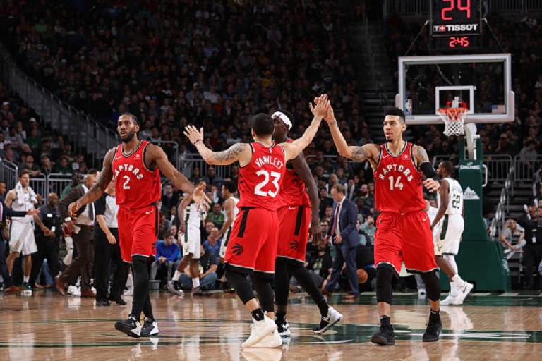 Fred VanVleet #23 of the Toronto Raptors hi fives teammates during the game against the Milwaukee Bucks on January 5, 2019 at the Fiserv Forum Center in Milwaukee, Wisconsin. PHOTO/GettyImages