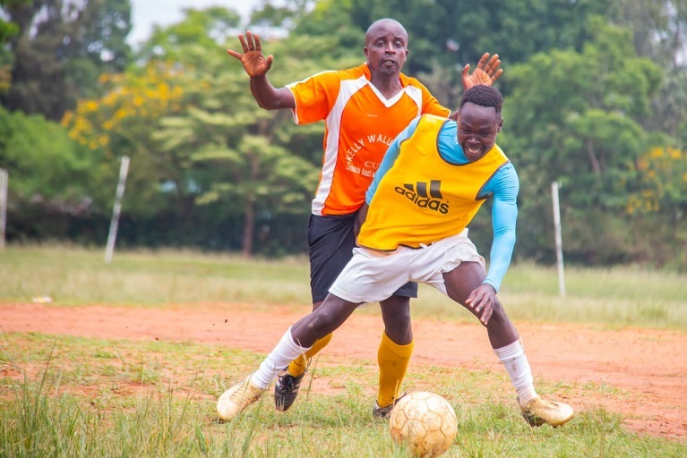 George Musumba of  Target FC  ( in black short) against Bungoma All Stars player tussle for the ball at Bungoma High School Ground on April 4, 2019. PHOTO/SPN/BRIAN KINYANJUI