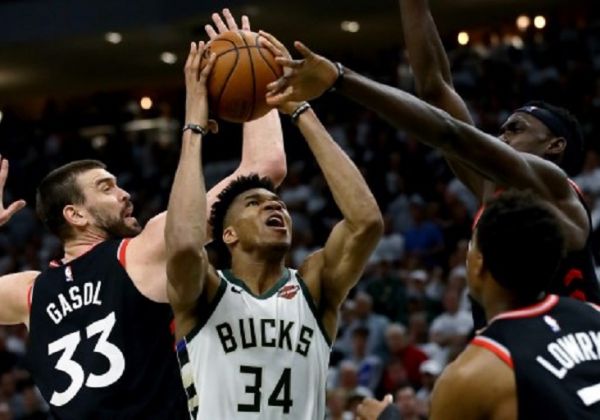 Giannis Antetokounmpo #34 of the Milwaukee Bucks attempts a shot while being guarded by Marc Gasol #33 and Pascal Siakam #43 of the Toronto Raptors in the fourth quarter in Game One of the Eastern Conference Finals of the 2019 NBA Playoffs at the Fiserv Forum on May 15, 2019 in Milwaukee, Wisconsin. PHOTO/ AFP