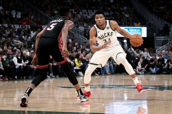 Giannis Antetokounmpo #34 of the Milwaukee Bucks dribbles the ball while being guarded by Derrick Jones Jr. #5 of the Miami Heat in the second quarter at the Fiserv Forum on October 26, 2019 in Milwaukee, Wisconsin. PHOTO | AFP