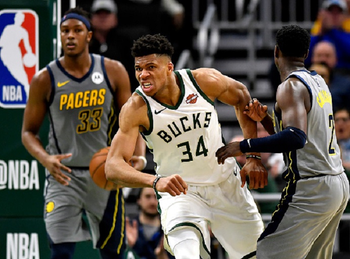 Giannis Antetokounmpo #34 of the Milwaukee Bucks reacts after scoring against Myles Turner #33 of the Indiana Pacers at Fiserv Forum on March 07, 2019 in Milwaukee, Wisconsin. PHOTO/GettyImages