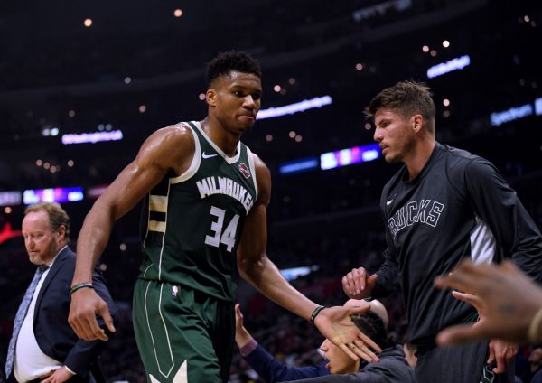 Giannis Antetokounmpo #34 of the Milwaukee Bucks reacts as he leaves the game with two fouls past Kyle Korver #26 during the first half at Staples Center on November 06, 2019 in Los Angeles, California. PHOTO | AFP