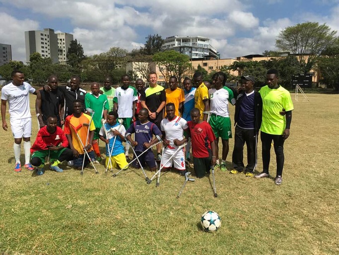 Gor Mahia FC and Rwandan international, Jacques Tuyisenge (left on the standing row) and head coach, Dylan Kerr (in the middle standing row with black and  yellow top) offers motivation to Kenya Amputee Football team that will represent the country in the World Cup in Mexico  starting October  24, 2018.PHOTO/COURTESY 