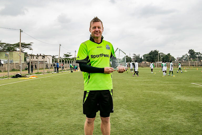 Gor Mahia FC head coach, Dylan Kerr, poses with his Fidelity Insurance/SJAK Coach of the Month Award for June at Nairobi's Camp Toyoyo Grounds on June 24, 2018. PHOTO/Duncan Sirma/SPN