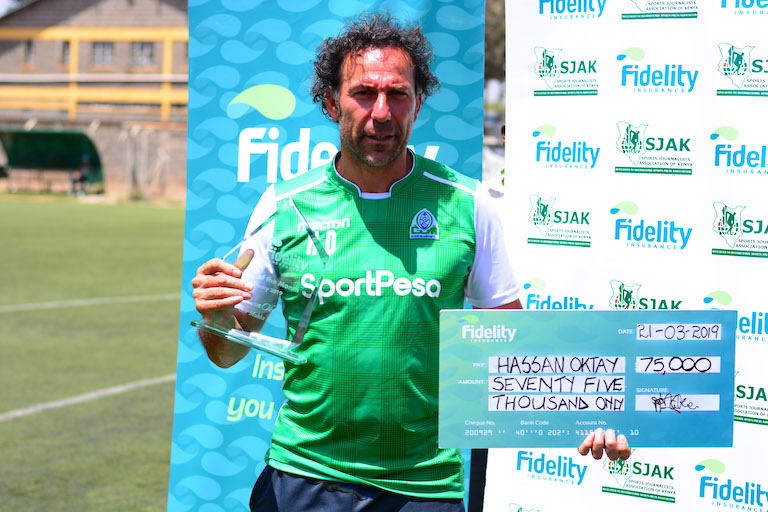 Gor Mahia FC head coach, Hassan Oktay poses with his trophy and KSh75,000 cheque when he was named the Fidelity Insurance/SJAK Coach of the Month for February on March 21, 2019. PHOTO/Courtesy