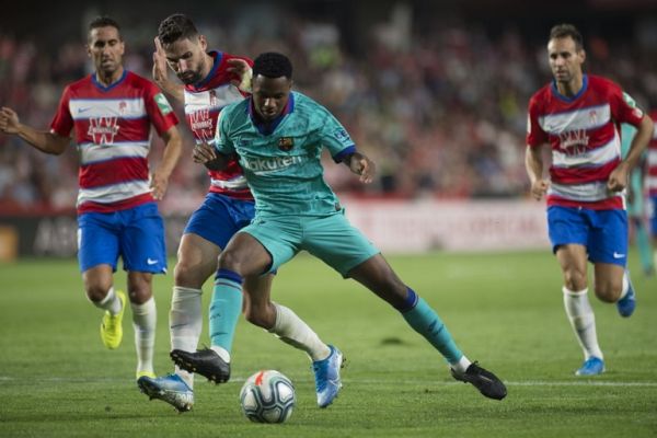 Granada's Spanish midfielder Antonio Puertas (2L) vies with Barcelona's Guinea-Bissau forward Ansu Fati during the Spanish league football match between Granada FC and FC Barcelona at Nuevo Los Carmenes stadium in Granada on September 21, 2019. PHOTO | AFP