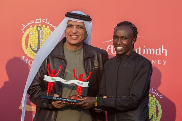 His Highness Sheikh Saud Bin Saqr Al Qasimi hands over the winner's trophy to Fancy Chemutai from Kenya (Right) who won the woman's RAK Half Marathon in a time of 1:04:53. PHOTO/ GETTY IMAGES